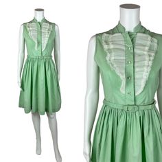 Vintage 1950s Mint Green Dress Women's Extra Small Sleeveless Ruffle Bib Belted Shirtdress You'll look as sweet as a scoop of mint ice cream in this darling 1950s shirt dress! This vintage beauty is a lovely shade of mint green with a white ruffle detail on the bodice, rhinestone buttons and a fitted waist with matching belt. Vintage dress zips up the side with a metal zipper. LABEL: - FABRIC: feels like cotton  MARKED VINTAGE SIZE: - SHOULDERS: 13.5" SHOULDER TO WAIST: 14.5" BUST: 35" WAIST: 26 1950s Vintage Summer Dress With Ruffles, 1950s Vintage Ruffled Dress For Summer, 1950s Style Vintage Ruffled Dress For Summer, 1950s Ruffled Vintage Dress For Spring, 1950s Style Sleeveless Green Dress, 1950s Style Sleeveless Spring Vintage Dress, Retro Sleeveless Vintage Dress For Daywear, Spring Sleeveless Vintage Dress, Sleeveless Vintage Dress For Spring