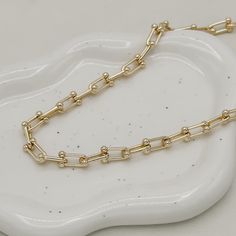 The Ryker Necklace, a timeless piece, embodies luxury and sophistication. Crafted from 18K gold filled materials, this 8mm bead link chain features a lustrous finish and a versatile 18-inch length with a 2" extender. Its refined elegance makes it a must-have for those who appreciate quality craftsmanship and style. Perfect for any occasion, it's sure to make a statement. 18" with 2" extension 18k gold filled demi-fine Elegant 14k Gold-filled Oval Link Necklaces, Elegant 14k Gold Filled Oval Link Necklace, Formal Gold Plated Necklace With Paperclip Chain, Formal Gold-plated Necklace With Paperclip Chain, Timeless Gold-plated Chain Necklace, Elegant Gold-tone Cable Chain Necklace, Elegant Gold-plated Paperclip Chain Bracelet, Luxury Tarnish-resistant Oval Link Chain Necklace, Gold Chain Link Necklace For Everyday Luxury