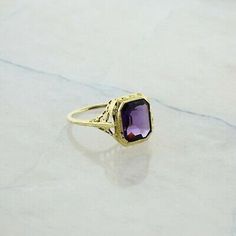 "Antique 10K Yellow Gold Octagonal Amethyst Filigree Ring, art deco style, 7x9mm bezel set, deep amethyst stone, millegrain setting, pierced decoration, .5\" across, nice quality, Ring size 6.5, Circa 1930, 2.2 grams Stock # BB227R16 This listing contains photographs of the actual item you will receive. Our items are in excellent condition with little or no signs of wear and many are one of a kind pre-owned estate finds. Please look closely at the pictures in this listing as they are part of the Heirloom Amethyst Ring In Yellow Gold With Bezel Setting, Formal Gold Amethyst Ring With Bezel Setting, Classic Yellow Gold Rectangular Amethyst Ring, Art Deco Ring With Bezel Setting, Heirloom Gold Amethyst Ring With Bezel Setting, Vintage Emerald-cut Amethyst Ring For Anniversary, Vintage Emerald Cut Amethyst Ring For Anniversary, Heirloom 14k Gold Amethyst Ring With Bezel Setting, Art Deco 14k Gold Ring With Bezel Setting