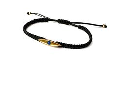 Handmade braided bracelet cord with Eye charm. Bracelet for men. Materials: 🔹 24k gold plated charm/ Enamel eye 🔹 Waterproof String 🔹 Finished with a sliding knot closure, adjustable size bracelet All items are handmade with love just for you! 🔹 Check out our shop for more jewellery https://www.etsy.com/shop/JustSeedBeads?ref=seller-platform-mcnav§ion_id=23857241 Thank you! Gold Braided Evil Eye Bracelet As A Gift, Gold Braided Bracelet With Evil Eye For Gift, Gold Braided Bracelet With Evil Eye As Gift, Gold Spiritual Bracelet With Adjustable Cord, Spiritual Gold Bracelet With Adjustable Cord, Adjustable Handmade Gold Evil Eye Bracelet, Gold Evil Eye Bracelet With Adjustable Length As Gift, Gold Bracelets With Adjustable Waxed Cord, Adjustable Yellow Gold Evil Eye Bracelet