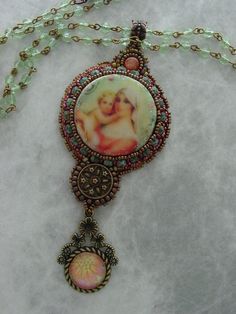 Beautiful Mother and child made from wood and sealed to perfection. Surround by beads, and adorned with a Sun stone on top ,and a vintage button below. This necklace has the feel of a rosary, with a glass cabochon hanging from the bottom This pendant measures 4 inches long x 1 1/2 inches wide, and hangs from a 36 inch crystal chain, that can be wrapped around the neck twice for a shorter look, or hang long. Vintage Beaded Round Pendant Jewelry, Vintage Beaded Medallion Jewelry, Vintage Healing Jewelry With Czech Glass, Vintage Czech Glass Jewelry For Healing, Handmade Vintage Pendant Beaded Necklaces, Vintage Beads And Cabochons For Jewelry Making, Vintage Beaded Pendant Necklace For Gift, Vintage Beaded Round Pendant Necklace, Vintage Handmade Beaded Necklaces As Gift