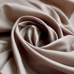 a close up view of the fabric on a bed sheet that has been made to look like silk