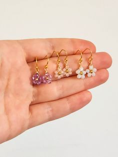 Crystal Daisy Dangle Earrings Inspired by dainty daisies, these cute dangle earrings are the perfect addition to your look. Ideal for those who love a floral design and drop style earrings. Makes for a lovely custom gift or a present for yourself! DETAILS Materials: Glass crystals, Gold color wire and beads If you have any questions send me a message so we can chat! 🥰 Handmade Flower Crystal Earrings For Gifts, Dainty Hypoallergenic Dangle Crystal Earrings, Flower Shaped Crystal Earrings With Flower Charm For Gifts, Flower Shaped Crystal Earrings With Flower Charm, Flower-shaped Crystal Earrings With Flower Charm As Gift, Flower-shaped Crystal Earrings With Flower Charm, Handmade Dainty Crystal Drop Earrings, Delicate Tiny Flower Earrings For Gift, Dainty Dangle Flower Earrings For Gift