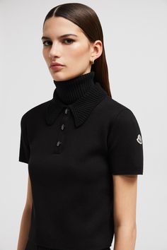 This polo shirt is crafted from extra-fine Merino wool for unparalleled softness. The design boasts a delicate knit collar, playing with textures to infuse the style with a feminine feel. Luxury Wool Tops With Ribbed Collar, Elegant Black Polo Collar Sweater, Elegant Short Sleeve Polo Sweater With Ribbed Collar, Fitted Polo Sweater With Seamless Collar, Elegant Fitted Polo Shirt With Ribbed Collar, Fitted Wool Polo Collar Tops, Luxury Fitted Merino Wool Top, Fitted Wool Tops With Polo Collar, Luxury Black Wool Top