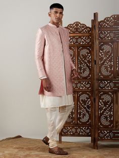 Vastramay Men's Peach Sequined Indo Western Sherwani With Kurta Pyjama Set Make a statement at weddings and festive occasions with this elegant Indo Western Sherwani set from VASTRAMAY. Crafted in a peach hue with sequin detailing, this outfit exudes traditional charm with a modern twist. The set includes a Sherwani and matching Kurta Pyjama. Features: Sequined detailing for a stylish look Modern Indo Western design Includes Sherwani and Kurta Pyjama Perfect for weddings and festive occasions Sp Festive Straight Kurta Bandhgala For Reception, Bandhgala Straight Kurta For Diwali Reception, Diwali Reception Bandhgala Straight Kurta, Formal Pink Kurta With Naqshi Detailing, Pink Kurta For Reception And Transitional Season, Pink Traditional Naqshi Sherwani, Traditional Drape Nehru Jacket For Diwali Reception, Pink Nehru Jacket With Zari Work, Pink Nehru Jacket For Diwali With Traditional Drape