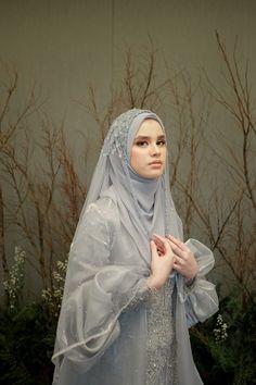 a mannequin dressed in a blue dress and veil