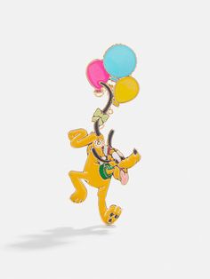 a pin with a cartoon character holding balloons in the shape of a dog on it's back