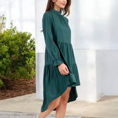 Add a touch of elegance to your wardrobe with the Anna-Kaci Women's High Neck Tiered Swing Dress. This beautiful dress features a high neckline and a tiered design that creates a flowing silhouette, perfect for any occasion. The long sleeves add a modest yet stylish element, while the swing cut ensures a comfortable and flattering fit. Whether you're heading to a special event or a casual outing, this dress is a versatile piece that pairs effortlessly with heels or flats for a chic look. Elegant Mini Dress With Layered Hem For Brunch, Elegant Knee-length Dress With Layered Hem, Chic Green Midi-length Tiered Dress, Chic Green Midi Length Tiered Dress, Fitted Green Tiered Dress, Elegant Green Tiered Skirt Dress, Elegant Brunch Dress With Layered Hem, Elegant Layered Hem Dress For Brunch, Elegant Dresses With Layered Hem For Brunch