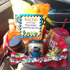 the back seat of a car filled with food and condiments, along with a sign that reads nacho average teacher thanks for a great year