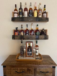 two wooden shelves with liquor bottles on them