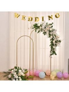 the wedding arch is decorated with flowers and balloons