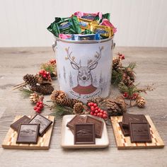 chocolates and candy are arranged in front of an ice bucket on a wooden table