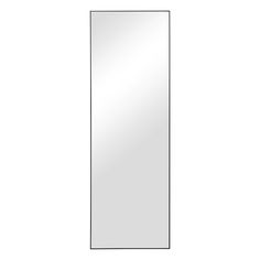 a tall mirror sitting on top of a white wall