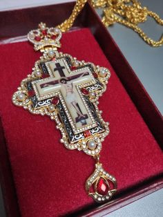 Orthodox pectoral cross, red stones cross for priest, brass chrest cross, pendant crucifix with golden Jesus, necklace religious gift idea Made of high-quality brass.  Decorated with red stones and pearls. Good gift idea for priests. Standard delivery abroad takes 2-3 weeks. So if You need a product from our shop as a gift for a special event, please, be ready that the whole process will take a few weeks. We can add the gift card to the order. Red Cross Pendant Necklace For Gift, Red Cross Pendant Necklace Gift, Red Crucifix Cross Necklace Gift, Cross Necklace With Large Pendant As A Gift, Red Crucifix Cross Necklace For Gift, Large Pendant Cross Necklace As Gift, Large Pendant Cross Necklace For Gift, Gift Cross Necklace With Large Pendant, Spiritual Red Cross Pendant Necklace