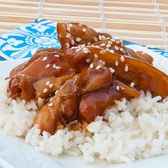 a white plate topped with rice and meat