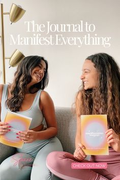 two women sitting on a couch holding books and smiling at each other with the title, the journal to manifest everything