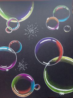 an image of colored bubbles on black paper