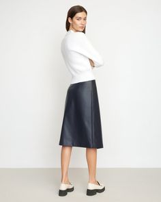 A sleek, asymmetric midi cut from soft vegan leather — Alba is the perfect staple you'll reach for season after season. We love to style this skirt with a cozy sweater and tall boots for a chic winter look. See below for our general Size Guide and available measurements Self made of 100% polyurethane, lining made of 100% polyester Machine wash cold and tumble dry low Leather Midi Skirt For Work, Modern Skirt With Asymmetrical Hem For Work, Sleek Midi Skirt For Fall, Sleek Asymmetrical Workwear Skirt, Spring Leather Midi Skirt, Spring Leather Midi-length Skirt, Winter Leather Midi Skirt, Versatile Knee-length Skirt For Fall, Versatile Fall Skirt With Lining