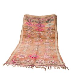 an old rug with fringes and flowers on the bottom is laying on a white surface