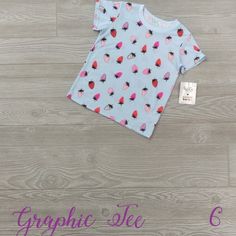 Dotdotsmile Graphic Tee Former Merchandiser Brand New With Tags Size 6 Light Blue T-Shirt With Red And Pink Strawberries Cute Polka Dot Top For Spring, Cute Spring Polka Dot Tops, Polka Dot Cotton T-shirt With Short Sleeves, Cotton T-shirt With Polka Dot Pattern And Short Sleeves, Trendy Polka Dot Cotton Tops, Trendy Polka Dot Short Sleeve Tops, Trendy Short Sleeve Tops With Polka Dot Pattern, Polka Dot Short Sleeve T-shirt For Spring, Fun Pink Tops With Strawberry Print