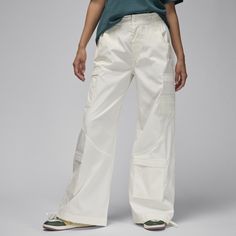 These pants pair the luxe quality and timeless story of Jordan Brand with a modern, wide-leg silhouette. Cinch ties at the ankle let you switch up your fit, while the all-over cargo pockets double down on utility and style. Modern Spring Cargo Pants, Modern Spring Cargo Pants With Cargo Pockets, Modern Spring Cargo Pants With Pockets, White Wide-leg Utility Cargo Pants, Modern Wide-leg Cargo Pants With Pockets, Modern Wide Leg Pants With Cargo Pockets, Modern Wide Leg Cargo Pants With Side Pockets, Modern High-waisted Cargo Pants For Spring, Modern High-waisted Spring Cargo Pants