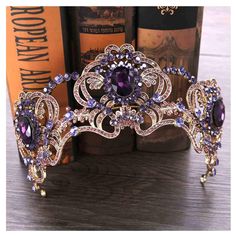 a purple tiara sitting on top of a wooden table next to some book cases