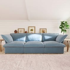 a blue couch sitting in the middle of a living room