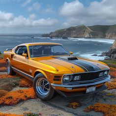 an orange and black car parked on the side of a road next to the ocean