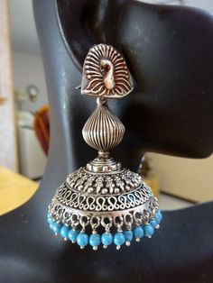 "These are an exquisite pair of jhumkas very ornate and the peacock posts add elegance! Blue beads complement very well! Let me know if you want all silver beads or differnt crystals- happy to customize. All custom requests will be extra! These jhumkas are on the large side but not heavy at all! These are famous in Jaipur, Rajasthan and all over India, wear this with a tunic top on jeans or shorts, simply out of this world. Wear these to your favorite Indian Restaurant Total length from top of the ear wire 2.5\".  WIdth-1.8\". Metal - oxidized Sterling Silver. Please feel free to ask me for more pictures or questions. Thank You for Shopping Jhumkas they are Ancient, Elegant, Opulent and Regal!" Bohemian Peacock Design Jhumkas As Gift, Bohemian Peacock Design Jhumkas For Gift, Bohemian Peacock Design Jhumkas, Bohemian Jhumkas With Peacock Design As A Gift, Bohemian Peacock Design Danglers For Diwali, Bohemian Peacock Danglers For Diwali, Elegant Blue Jhumkas With Latkans, Blue Temple Jewelry Jhumkas For Diwali, Blue Tilla Jhumkas For Festivals