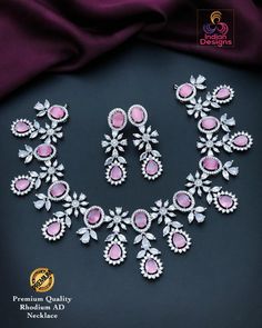 Elevate your elegance with this premium quality Silver/Rhodium finish AD necklace set, featuring stunning pink gemstones. The intricate design showcases a harmonious blend of pear and marquise-shaped stones, complemented by dazzling American diamonds. This set includes a matching pair of earrings, making it perfect for special occasions, weddings, or festive celebrations. The combination of the lustrous rhodium finish and vibrant pink stones adds a touch of sophistication and glamour to any outf Elegant Pink Hand Set Jewelry Sets, Pink Diamond Jewelry Sets For Wedding, Pink Diamond Wedding Jewelry Set, Pink Hand Set Round Jewelry Sets, Elegant Pink Cubic Zirconia Bridal Necklace, Formal Pink Hand Set Bridal Necklace, Hand Set Pink Bridal Necklace, Pink Cubic Zirconia Bridal Necklace For Party, Formal Pink Cubic Zirconia Bridal Necklace