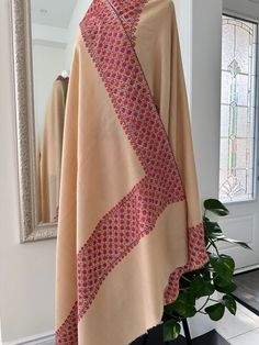 100% Hand-Embroidered Kashmiri Toosh Pashmina Shawl. Immerse yourself in the luxurious warmth and exquisite craftsmanship of this masterpiece. Painstakingly embroidered by skilled artisans, every intricate detail tells a tale of dedication and precision. Made from the finest Pashmina wool, this shawl embodies timeless elegance and sophistication. A perfect blend of heritage and luxury, it is a wearable work of art that adds a touch of opulence to any ensemble. Wrap yourself in the unmatched beau Beige Bohemian Traditional Wear For Wedding, Bohemian Traditional Wear For Wedding In Beige, Festive Beige Shawl For Wedding, Beige Pashmina Shawl For Wedding With Traditional Drape, Beige Traditional Wear With Embroidered Border, Beige Pashmina Shawl Dupatta For Wedding, Beige Wedding Pashmina Shawl With Traditional Drape, Cream Traditional Wear With Embroidered Border For Wedding, Cream Embroidered Traditional Wear For Wedding