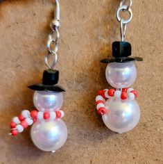 Festive fun holiday earrings, snowman earrings for Christmas, holiday party earrings with snowman snowmen earrings, cute Christmas earrings with snowman, fun festive Christmas earrings, fun cute holiday earrings, christmas party jewelry earrings, holiday party jewelry earrings, mini snowman earrings, tiny snowman party earrings, new years eve earrings, holiday party jewelry, cute earrings for the holidays, cute earrings with Santa, red and white earrings, stocking stuffers for mom daughters ladi Beaded Snowman Earrings Diy, Christmas Earrings Ideas, Holiday Earring Ideas, Nickel-free White Earrings For Christmas, Christmas Earrings Diy, New Years Eve Earrings, Holiday Earrings Diy, New Years Earrings, Christmas Jewelry Ideas