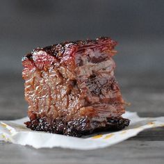 a piece of meat sitting on top of a napkin