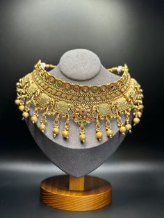 This South Indian Necklace Set Has A Beautiful And Lavish Appearance| Necklace & Earrings Set |  South Indian Choker Traditional Set Perfect Wedding Gift | Festival Special Jewelry | Kempu Temple Jewelry Set | Long Gold Necklace Set | Indian Necklaces are known for their delicate designs. Multicolor Metal Jewelry With Intricate Design, Bohemian Gold Plated Jewelry For Wedding, Ornate Multicolor Jewelry With Intricate Design, Ceremonial Dangle Jewelry With Intricate Design, Gold Jeweled Bridal Necklace For Ceremonial Use, Gold Jeweled Bridal Necklace For Ceremonial Occasions, Ornate Jeweled Ceremonial Jewelry, Temple Jewelry Latkans For Jewelry Making, Heavy Temple Jewelry Dangle Earrings