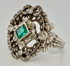 Art Deco Ring, Genuine Emerald Ring, Natural Diamond Ring, May Birthstone & 14K White Gold c.1920, Elegant Ring, Vintage Ring. This stunning estate ring is finely crafted in solid 14K White Gold and set with genuine Earth mined natural emerald and genuine diamonds. The center bezel set Emerald measures 5mm x 4.5mm (about .35ct). This is a very clean and transparent emerald with amazing intense green color with Natural inclusions. There are 56 natural diamonds in this ring for the total weigh Art Deco Green Emerald Ring With Rose Cut Diamonds, Art Deco Emerald Ring With Rose Cut Diamonds, Art Deco Emerald Jewelry With Rose Cut Diamonds, Fine Jewelry Emerald Ring With Intricate Design, Emerald Ring With Intricate Design, Art Deco Emerald Ring With 17 Jewels, Antique Emerald Cut Emerald Ring With Center Stone, Antique Hallmarked Emerald Ring, Victorian Style Collectible Emerald Ring