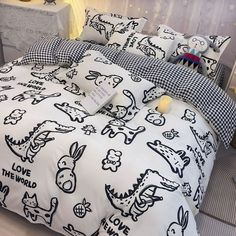 the bed is decorated with black and white cartoon characters on it, along with two night stands