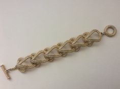 "Givenchy brushed gold, matte gold, satin gold twisted wire link bracelet Very good condition size - 7.5\" with clasp x 1\"" Elegant Gold-tone Bracelets With Clasp, Gold Metal Bangle Bracelet With Extender, Elegant Chain Link Bracelet With Gold Clasp, Elegant Chain Bracelet With Gold Clasp, Gold Jewelry With Lobster Clasp For Evening, Adjustable Formal Chain Bracelet With Clasp, Adjustable Chain Bracelet With Clasp For Formal Occasions, Adjustable Gold Bracelets For Evening, Adjustable Yellow Gold Bracelets For Evening