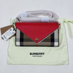 New with a tag. Comes with Authenticity Card and Dust bag. 100% Authentic Guarantee. We ONLY Sell Authentic Merchandise. We source our products directly from brand stores and luxury retail store within the United States and sell items that are 100% authentic.  Details: Burberry "Hannah" wallet in check leather, and fabric  Leather shoulder strap Can be worn as a shoulder bag, crossbody or wallet  Flap top with magnetic closure; punctuated with a polished press stud engraved with logo Center zip compartment divides interior; 12 card slots and two slip pockets  We inspect each item very carefully and disclose any flaws if we find them. If you notice any flaws that we did not mention please contact us first before leaving any negative feedback. We are only human and make mistakes.  All Sales Luxury Retail Store, Envelope Wallet, Envelope Bag, Burberry London, Burberry Women, Press Studs, Retail Store, Sell Items, Long Wallet