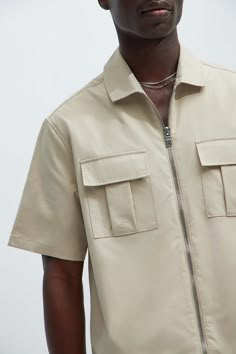 Available In Taupe, Black, Olive Fold Down Collar Front Zipper Closure Chest Pockets 100% Polyester Imported | Mens Fulton Zip Shirt in Taupe size XL by Fashion Nova Button Up Shirt Design Ideas, Luxury Khaki Tops For Men, Men T Shirt Design Ideas, Beach Outfit Men Beachwear, Luxury Khaki Men's Shirt, Work Shirt Outfit, Utility Button-up Shirt For Streetwear, Men Shirt Design, Khaki Button-up Shirt With Placket