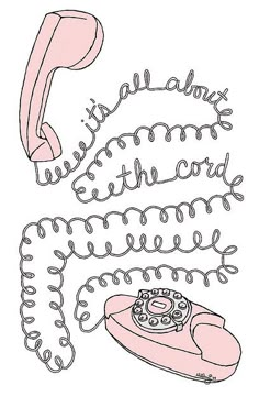 an old fashioned pink phone with handwritten text on the front and back, sitting next to a telephone cord