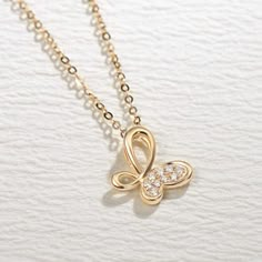 Inspired by infinity and butterfly symbols, this gold ribbon elegantly embrace brilliant diamonds and creates a sophisticated look. Made with 18k solid real yellow gold and diamond. Dimension: 11.6 mm x 12 mm Chain Length: 16"+2" Minimum Total Carat Weight﻿: 0.065 cttw Origin: Imported Gold Infinity Necklace With Diamond Accents, Gold Infinity Necklaces With Diamond Accents, Gold Diamond Infinity Necklace, Gold Diamond Butterfly Jewelry, Gold Butterfly Diamond Jewelry, Gold Cubic Zirconia Butterfly Necklace With Clavicle Chain, Elegant 14k Gold Butterfly Pendant Necklace, Elegant Butterfly Pendant Necklace For Anniversary, Elegant Yellow Gold Butterfly Necklace