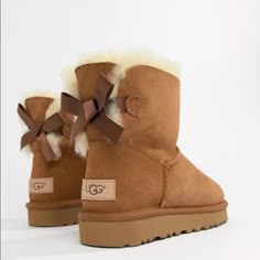 Brand New In Box Ugg Bailey Mini Bow Boots Ii. Size 9. Chestnut Brown Color. Perfect To Give As A Gift With Original Packaging And Box! Backed With A Ribbon Bow, The Bailey Bow Ii Boots From Ugg Are A Playful Take On Their Iconic Silhouette. Shaft Height: 6" Round-Toe Slip-On Boots Bow Detail At Back Water Resistant Suede And Stain Resistant Upper Pieced, Dyed Sheepskin Fur Upper 17 Mm Sheepskin Lining And Insole, And Treadlite Outsole For Comfort Sheepskin Upper; Wool Lining; Polyester Backi Bailey Bow Uggs Ugg, Uggs Boots Ugg, Brown Bow Ugg Boots, Uggs Boots Winter, Cutest Ugg Boots, Ugg Chestnut Boots, Ugg Classic Heritage Bow, Ugg Boots Nordstrom, Ugh Boots Bows