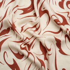 a red and white fabric with swirls on it