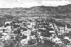 an aerial view of a city with mountains in the background