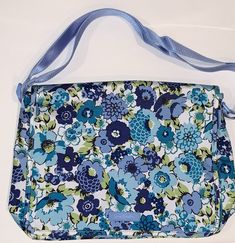 Vera Bradley Messenger Bag - New with Tags Lighten Up Nylon Material in Blueberry Blooms PATTERN 14"W x 12"H x 4" D with 56" adjustable shoulder strap. The exterior features one large back zip pocket and a front slip pocket under the flap with room for pen etc.  The interior has two more slip pockets and is lined in VB signature light blue nylon.    This bag is the lighten up nylon material not the quilted material From smoke-free environment Authentic Vera Bradley: Purchased by ME from Vera Bradley and a gift receipt from MY purchase is included Vera Bradley, Diaper Bag, Messenger Bag, Bags Handbags, Zip Pockets, Shoulder Strap, Shoe Accessories, Light Blue, Bag Lady