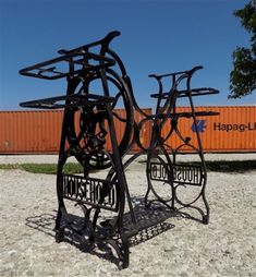 two metal sculptures are sitting in the sand