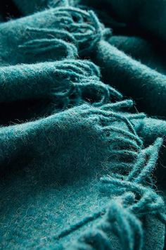 a close up view of some blue colored material that has been dyed with yarn on it