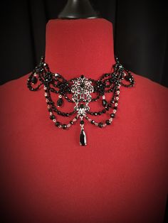 Unleash your dark elegance with our mesmerizing black crystal gothic necklace. Crafted with exquisite attention to detail, this enchanting piece features a deep black crystal pendant, creating an alluring contrast that captures the essence of gothic allure.  Whether you're embracing your inner romantic or channeling mystic energies, this unique necklace is the perfect accessory to express your individuality. Dark Elegance, Witch Necklace, Interactive Stories, Medieval Jewelry, Gothic Necklace, Gothic Wedding, Unique Necklace, Deep Black, Rhinestone Necklace