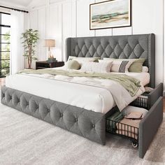 a bedroom with a large bed and drawers in it