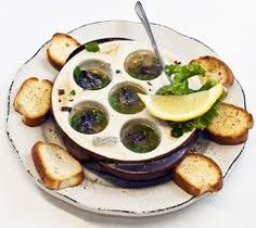 a white plate topped with bread and veggies on top of a saucer